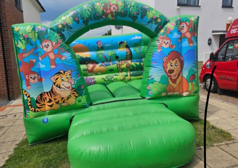 Jungle themed bouncy castle hire - Safari animal castle for adventure themed kids parties Essex
